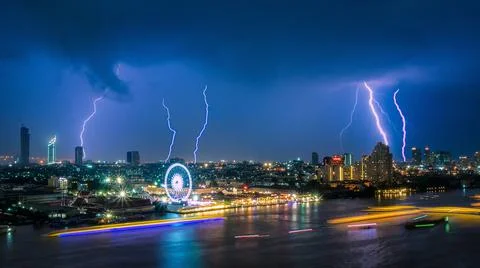 Thunder storm lightning strike on the dark cloudy sky over business building Photos