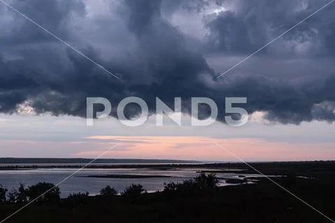 Thundercloud Armageddon over the lake at sunset. Kuyalnitsky estuary. Odessa. Stock Photos