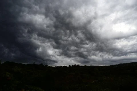 Thundercloud supercell seen from below, gray storm clouds Stock Photos