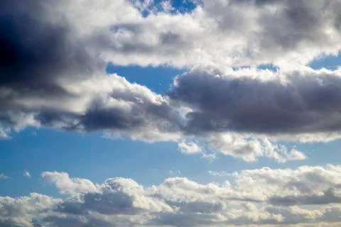 Thunderclouds clouds on blue sky. Grey white clouds in sunny day. Beautiful n Stock Photos