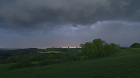 Thunderclouds  comes up over meadows in spring Stock Footage 273069599