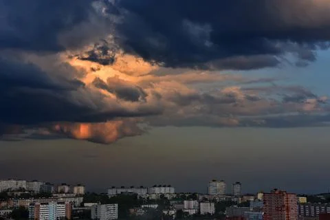 Thunderclouds on a dramatic stormy sky over the city Stock Photos