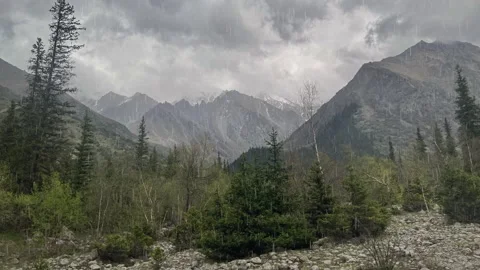 Thunderclouds in the mountains. It's pouring heavy rain Stock Footage 244119594