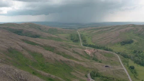 Thunderclouds over hilly terrain Stock Footage 245467088