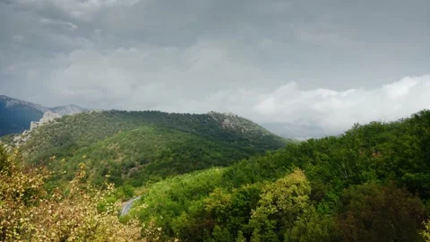 Thunderclouds over the mountain and the green valley through the autumn yellow Stock Footage 217406480