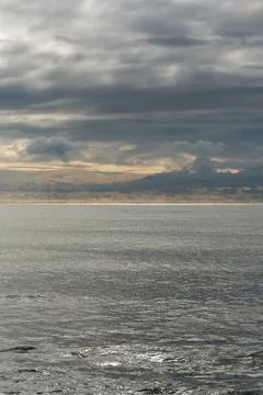 Thunderclouds over the sea. The approach of the storm. Stock Photos