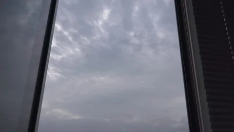 Thunderclouds quickly fly in the sky outside the window Stock Footage 107795349