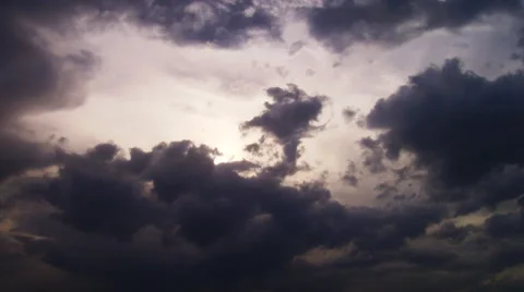 Thunderclouds roll across the sky with a weak sun shining through. Stock Footage 52327342