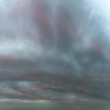 Thunderclouds turn pink at sunset after the rain Stock Photos