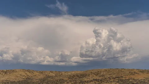 Thunderhead clouds over desert landscape Wyoming Stock Footage 167468279