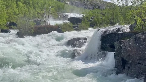Thundering water flows through rugged cascade landscape. Powerful rushing Stock Footage 327916874