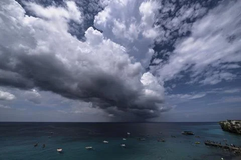 Thundershower scenery with flying clouds over the turquoise sea around Curacao Stock Photos