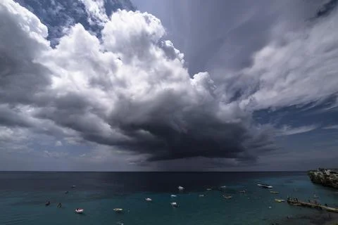 Thundershower scenery with flying clouds over the turquoise sea around Curacao Stock Photos