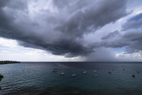 Thundershower scenery with flying clouds over the turquoise sea around Curacao Stock Photos