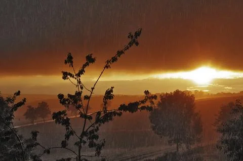 Thundershowers at sunset Stock Photos