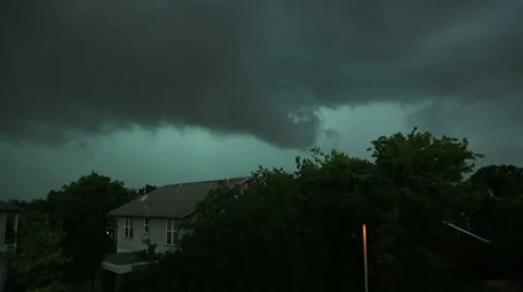 Thunderstorm and dark clouds with sheet lightening pass over house Stock Footage 24943667