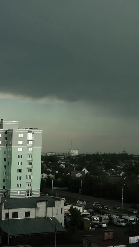 A thunderstorm and rain in a city with dark gray clouds in the sky Stock Footage 335378060