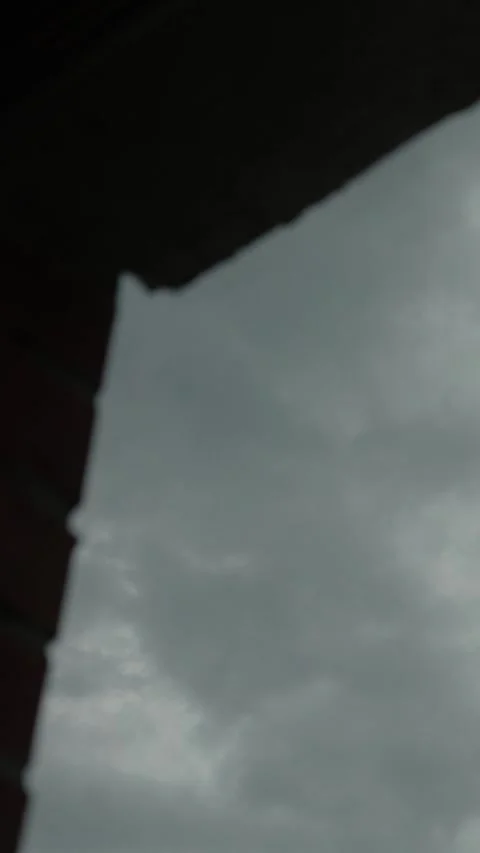 A thunderstorm and rain in a city with dark gray clouds in the sky Stock Footage 335378087