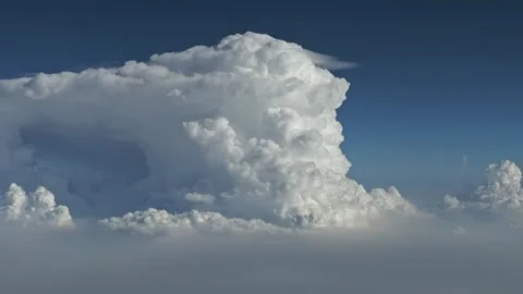 Thunderstorm with Anvil flying amongst clouds from cockpit window Stock Footage 280094332