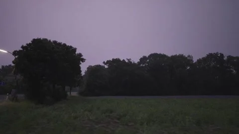 Thunderstorm bolts from the sky while driving along at a rainy day with dark Stock Footage 287469102
