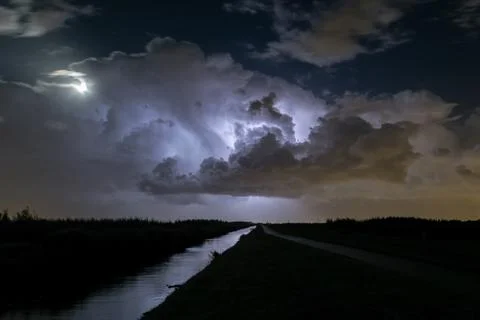 Thunderstorm clouds are illuminated by lightning Stock Photos