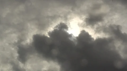 Thunderstorm clouds fly across sky, bright sun shines through dark clouds, rain Stock Footage 128801458
