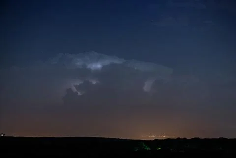 Thunderstorm clouds at night with lightning 스톡 사진
