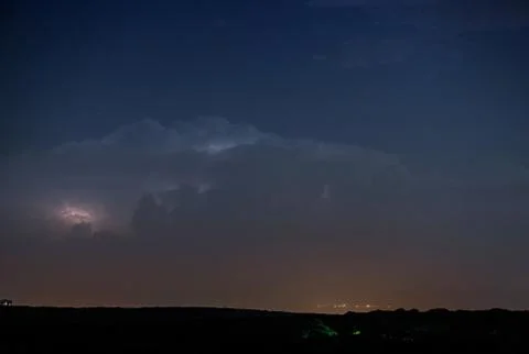Thunderstorm clouds at night with lightning Stock Photos