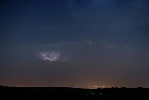 Thunderstorm clouds at night with lightning Stock Photos