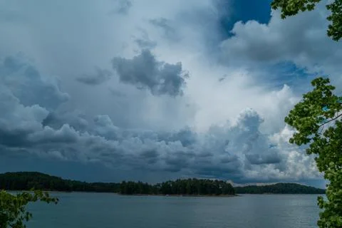 Thunderstorm clouds over the lake Stock Photos