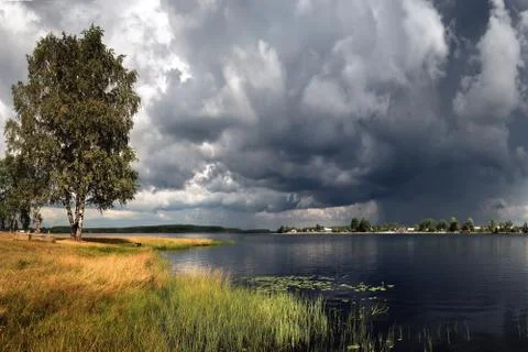 Thunderstorm is coming. Large clouds and clouds thickened on a summer day Stock Photos