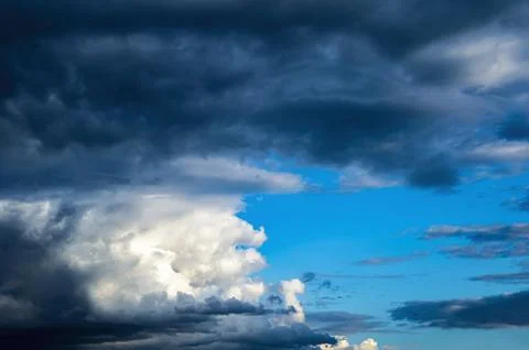 Thunderstorm cumulus clouds on blue sky. Stock Photos