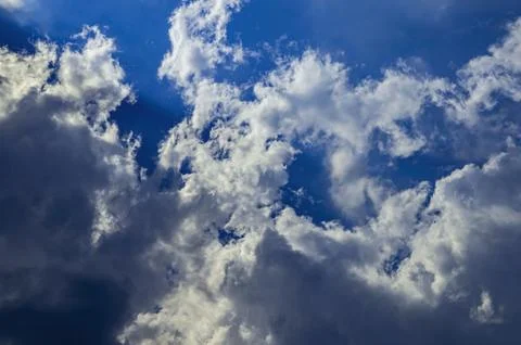 Thunderstorm cumulus clouds on blue sky. Stock Photos