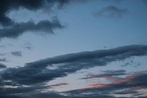 Thunderstorm dramatic clouds during evening sunset. Stock Photos
