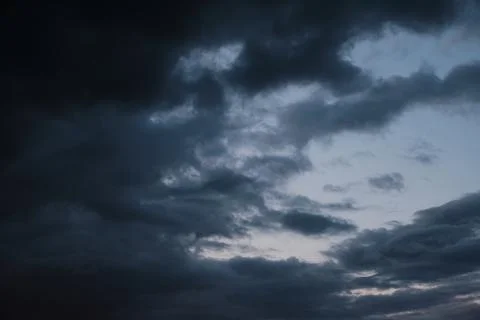 Thunderstorm dramatic clouds during evening sunset. Stock Photos