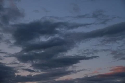 Thunderstorm dramatic clouds during evening sunset. Stock Photos