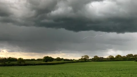 A thunderstorm with fork lightning in slow motion across a rural landscape Stock Footage 154319586