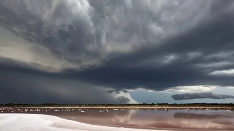 A thunderstorm forming above the lake Stock Footage