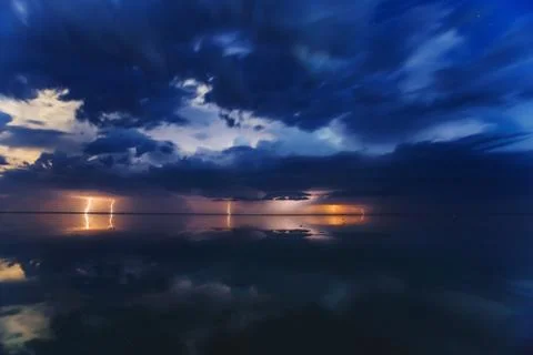Thunderstorm on the lake at night Stock Photos