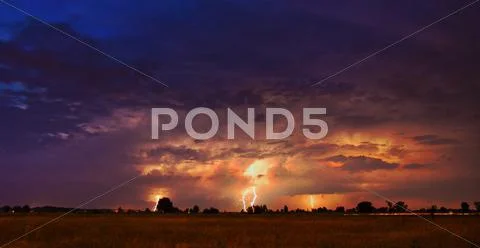Thunderstorm with lightning above land Stock Photos