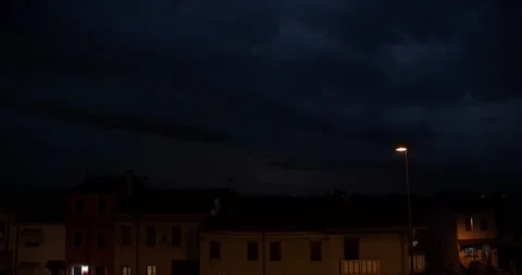 Thunderstorm with lightning in the clouds above roofs of houses. Видео 211720606