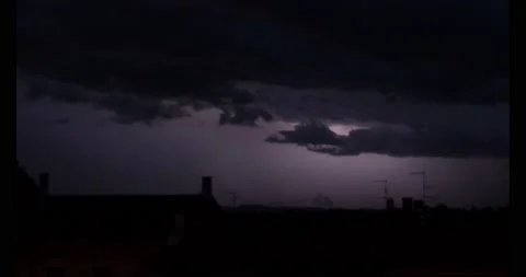 Thunderstorm with lightning in the clouds above roofs of houses. Stock Footage 211721334