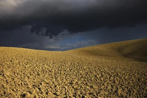 Thunderstorm on the plowed hill Stock Photos