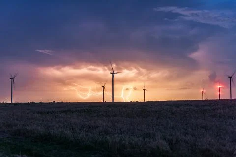 Thunderstorms over windmill. Lightning storms Stock Photos