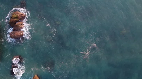 Thurlestone Rock Natural Arch in Turquoise Sea, Devon UK, Overhead Drone Shot Stock Footage 344437390