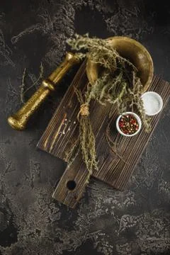 Thyme. Bunch of fresh herb thyme in bronxe mortar on rusty background Stock Photos