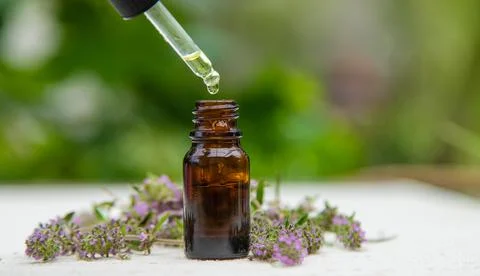 Thyme extract essential oil. Selective focus. nature. Stock Photos
