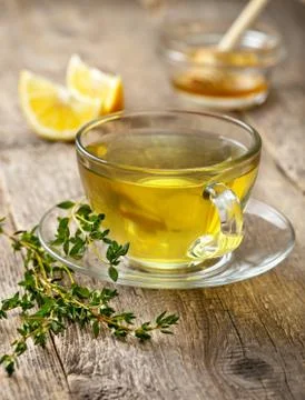 Thyme tea in glass cup Stock Photos