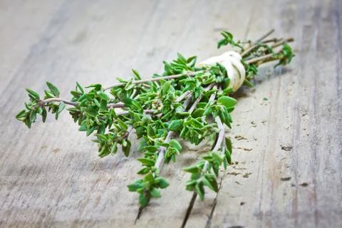 Thyme on wooden table Stock Photos