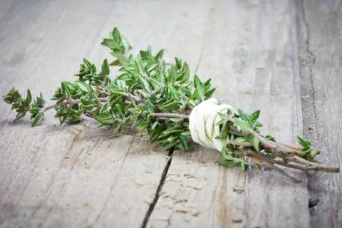 Thyme on wooden table Stock Photos